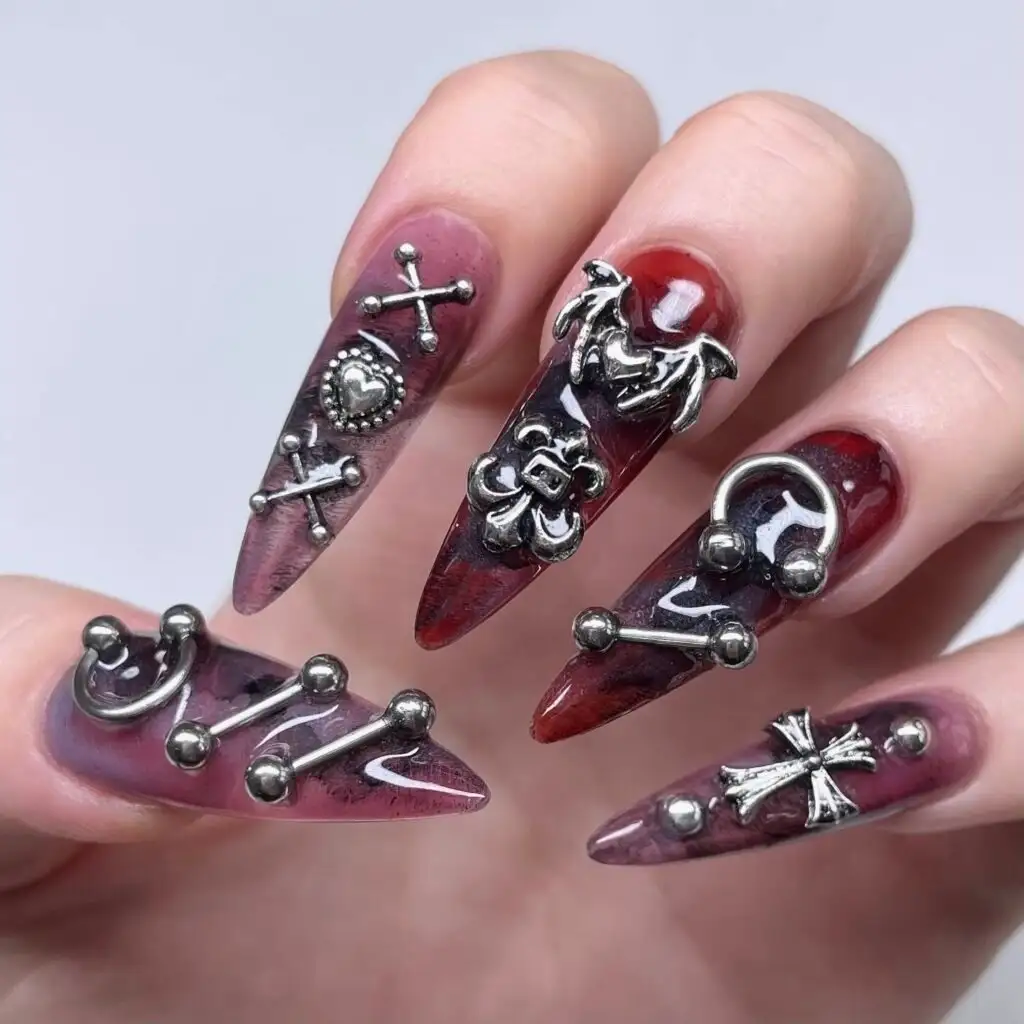Deep red marble stiletto set with silver cross charms and metal studs