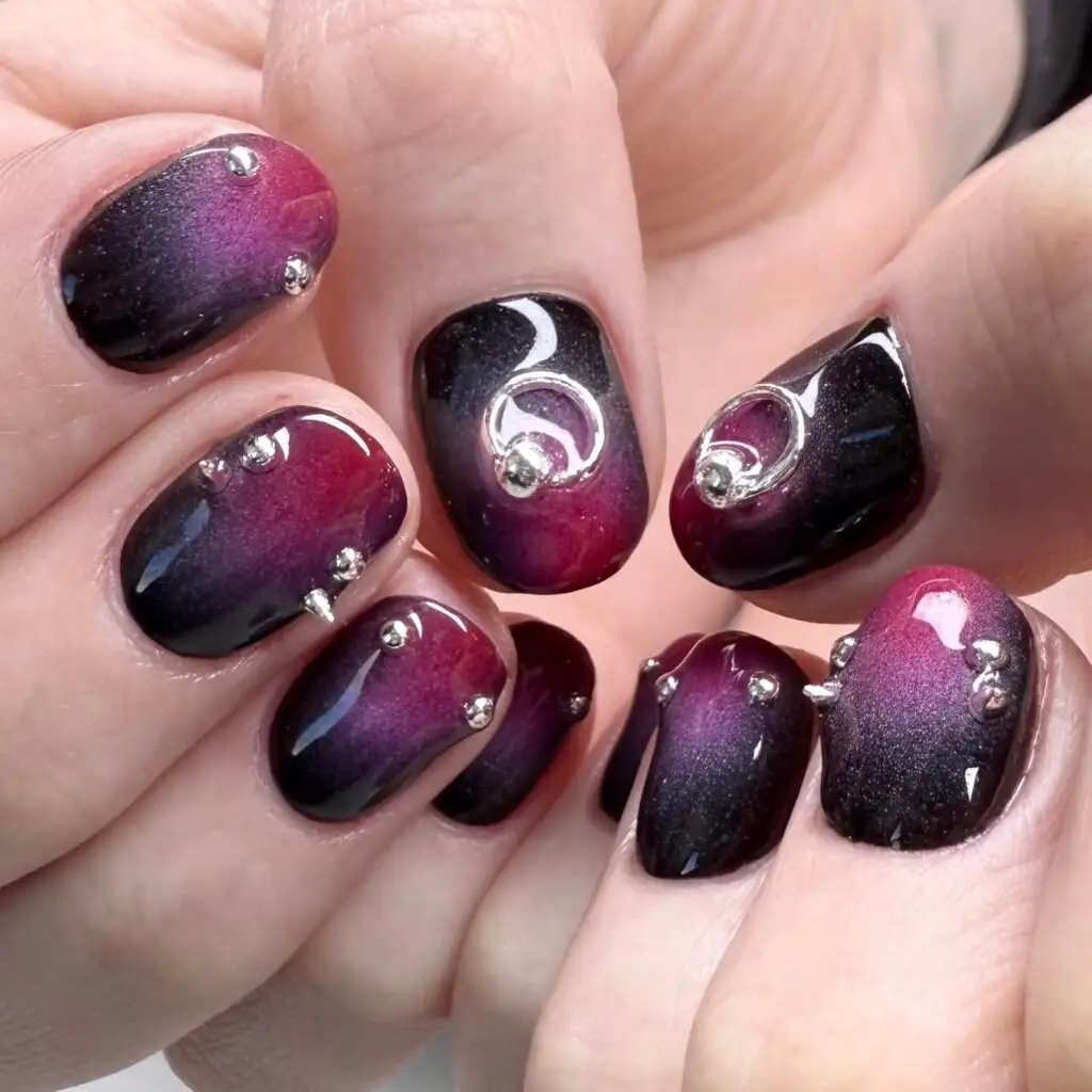 Magenta and black cat-eye set with silver rings and studs