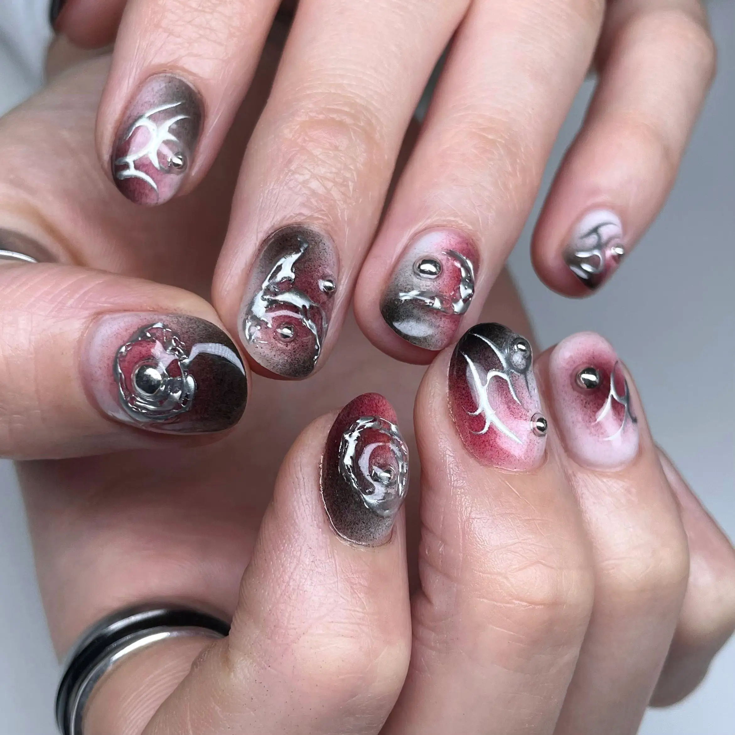 Chrome set in silver and red with sculpted 3D swirls