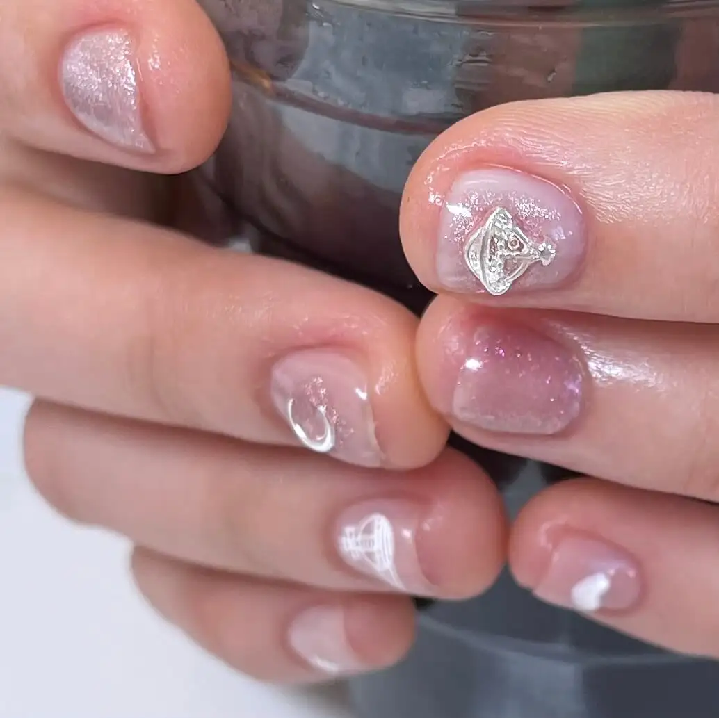 Natural short set with a soft shimmer and a single silver charm