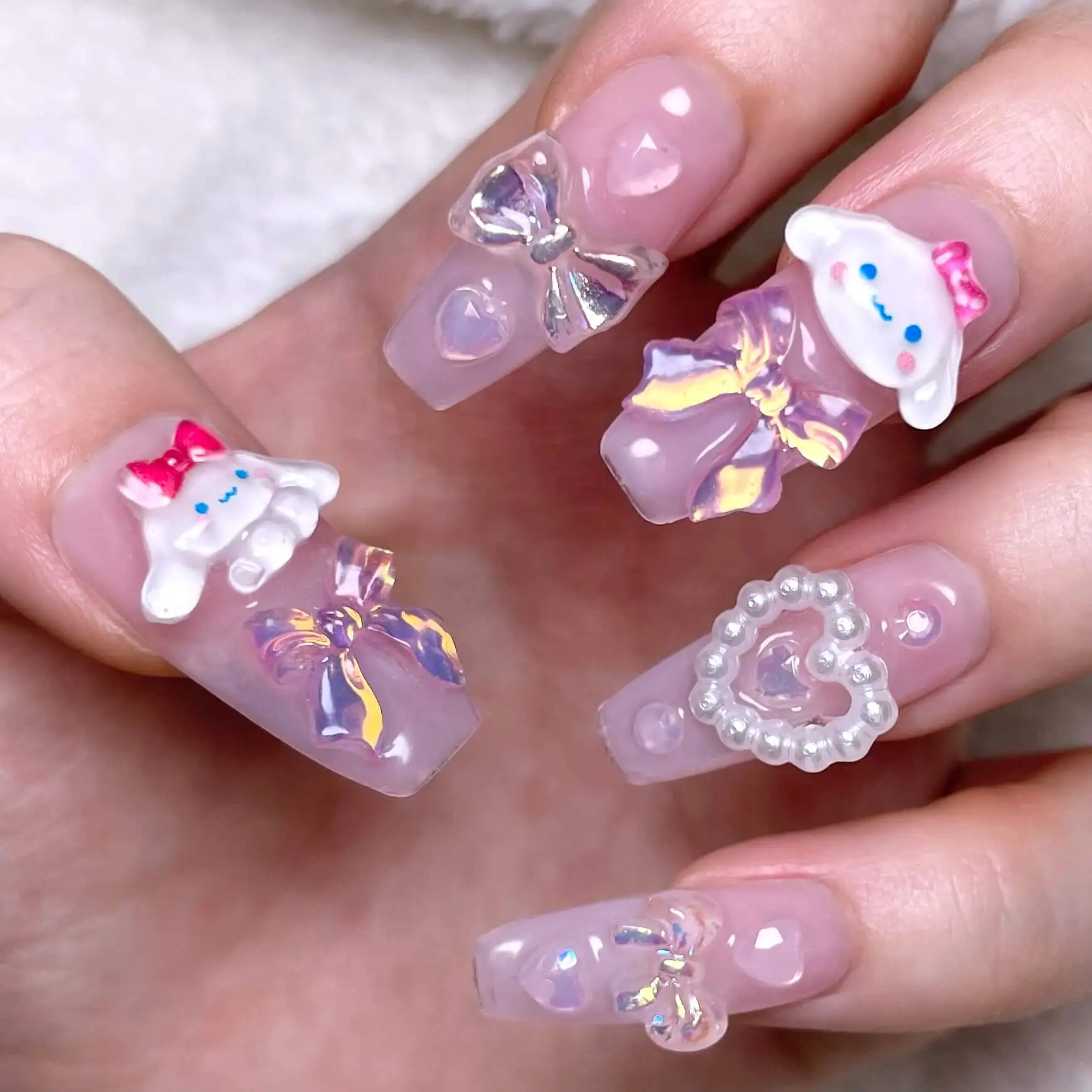 Long lilac nails with 3D bows, character charms and a pearl heart